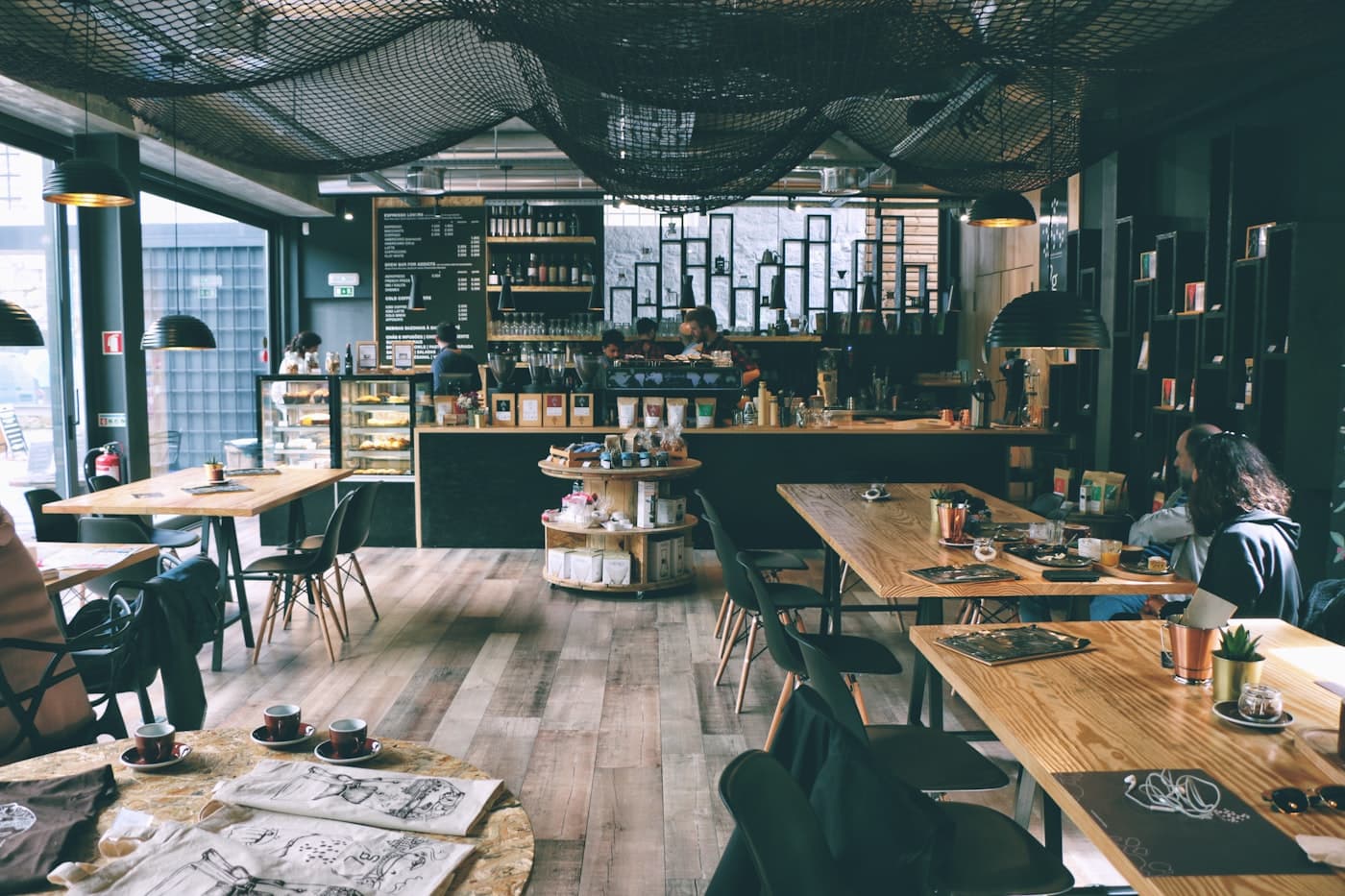 Busy modern cafe with customers working and socializing